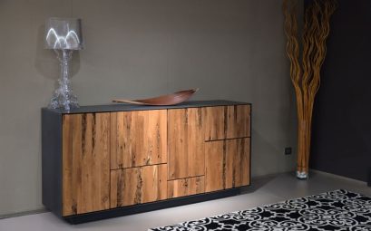 Stylish wooden cabinet with glass lamp in a contemporary interior setting.