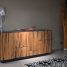 Stylish wooden cabinet with glass lamp in a contemporary interior setting.