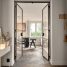 A hallway leading to a dining room with a table and chairs