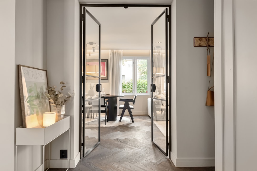 A hallway leading to a dining room with a table and chairs