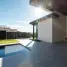 Modern outdoor patio with a swimming pool and outdoor kitchen.