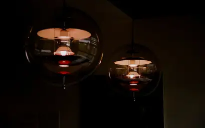 Stylish spherical pendant lights casting warm glow in a dim indoor setting.