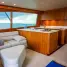 Spacious and elegantly designed yacht interior showcasing wooden furnishings and ocean view.