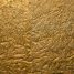 a close up of a metal surface with gold paint