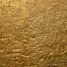 a close up of a metal surface with gold paint