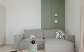Modern living room with gray sofa and green accent wall