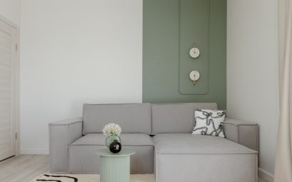Modern living room with gray sofa and green accent wall