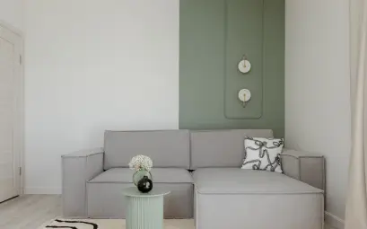 Modern living room with gray sofa and green accent wall