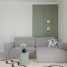 Modern living room with gray sofa and green accent wall