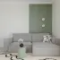 Modern living room with gray sofa and green accent wall