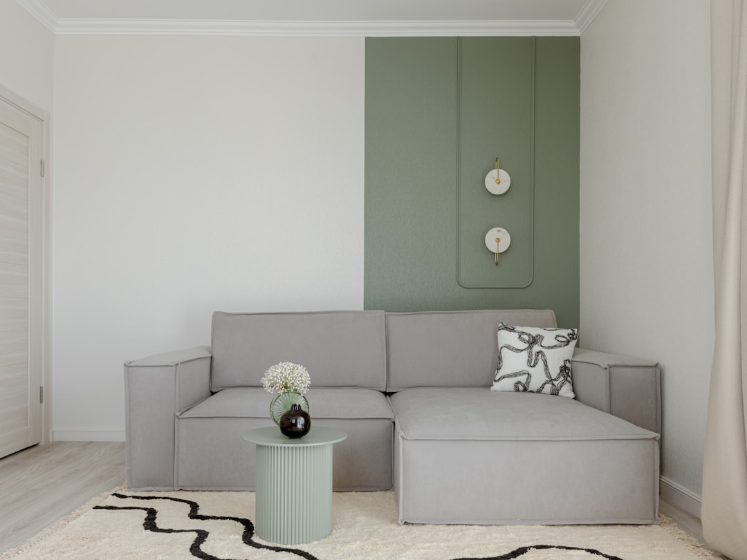 Modern living room with gray sofa and green accent wall