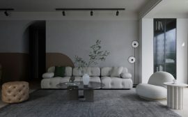 a living room with a couch, chair, table and speakers